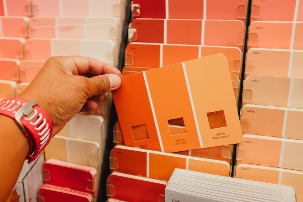 Shopping for the right color for an interior remodel by checking the paint samples at the local home
